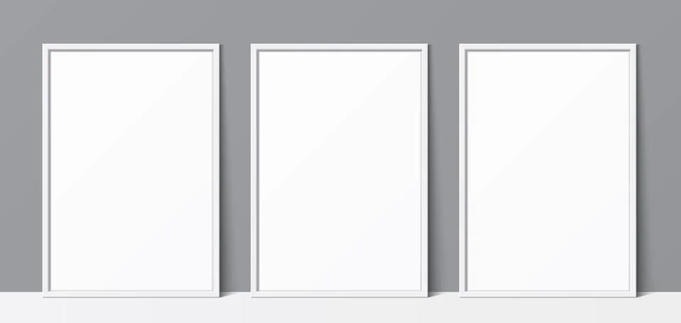 3 blank white frames leaning against a grey wall background, vector mockup. Illustrazione stock