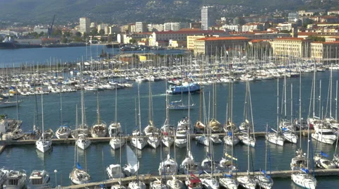 3 boats pull into marina harbor past many sailboats moored - 4K UHD 0811 Stock Footage 50145474