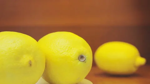 3 Bright Lemons 2 Of Yellow Fruits Rotating At Left Part Of Frame Video stock 100118614