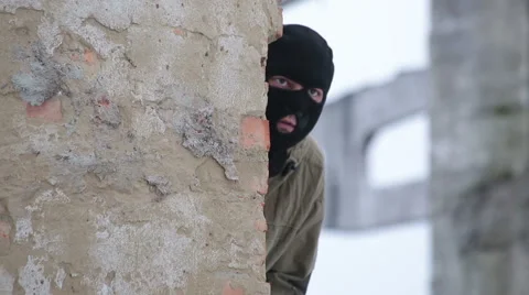 3 bullets fall into the wall, behind which hides the man Stock Footage 44786549