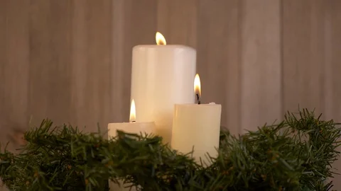 3 Candles Surrounded  by Christmas Tree on Wood Background Stock-Footage 128717097