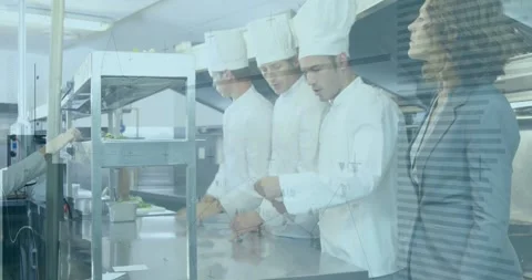 3 chefs placing plates at restaurant metal pass supervisor pointing order slip Stock Footage 334034732