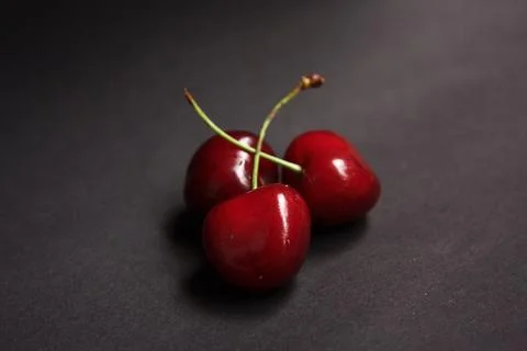 3 Cherries on a dark background Fotos Stock