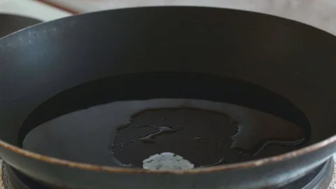 3 chicken eggs are broken into a frying pan Stock Footage 108000425