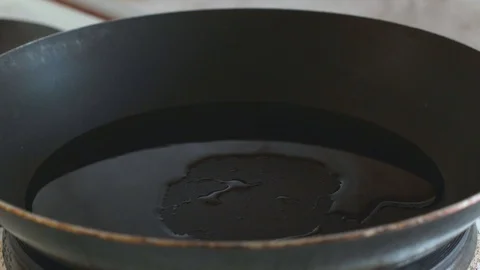 3 chicken eggs are broken into a frying pan slowmotion Stock Footage 108000472