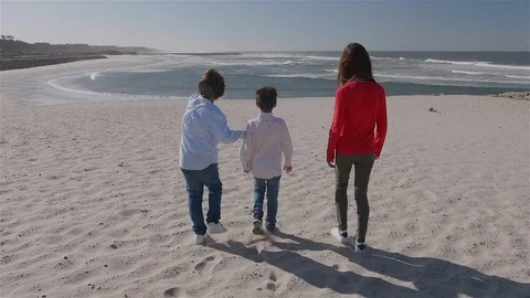 3 children walking on the beach towards the sea. Stock Footage 100587242