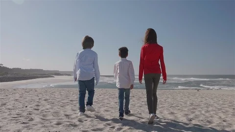 3 children walking on the beach towards the sea. Stock Footage 100587257