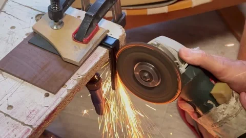 3 Close up of worker cutting metal piece with angle grinder tool in workshop Stock Footage 343421607
