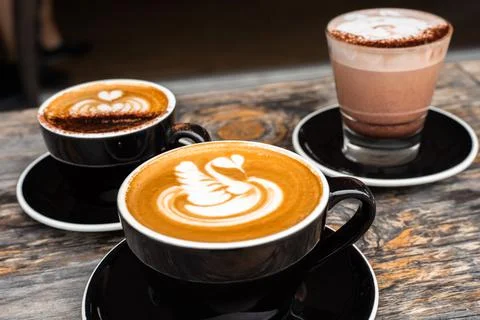 3 coffees hot chocolate latte art Stock Photos