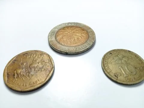 3 coins with different values from a bottom angle perspective. Stock Photos