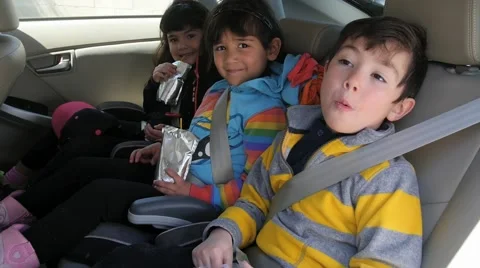 3 CUTE HISPANIC SIBLINGS IN CAR SEATS Stock Footage 63319697
