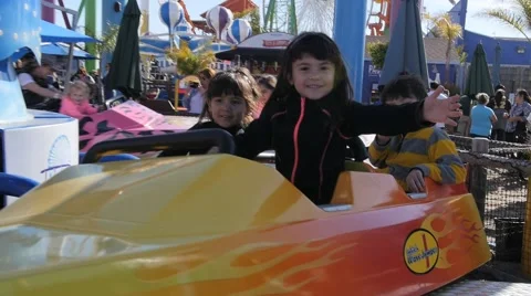 3 CUTE HISPANIC SIBLINGS RIDE AMUSEMENT PARK RIDE. Stock Footage 63319668