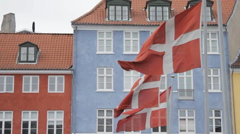 3 Danish flags flapping in the wind establishing shot Stock Footage