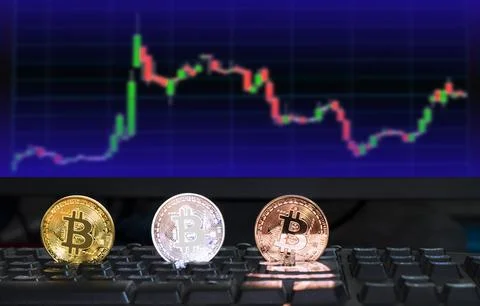 3 different colored bitcoin digital currency on computer keyboard with blur.. イラスト素材