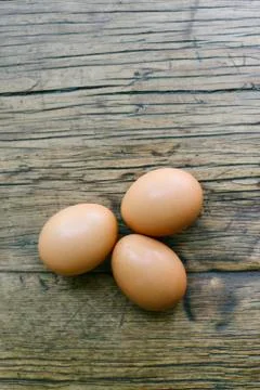3 Eggs and Copy Space on a Farm Table Stock Photos