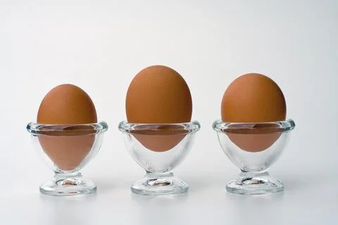 3 eggs in egg cups Stock Photos
