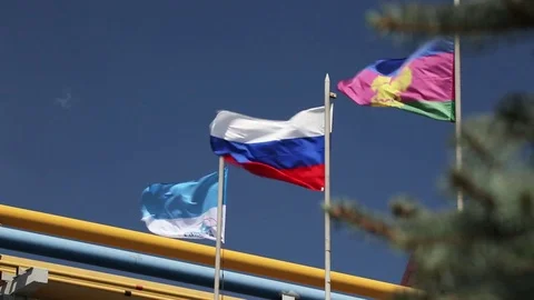 3 flags (one is russian) swinning in the wind  Stock Footage 72765789
