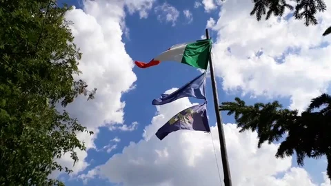 3 flags waving on blue cloudy sky. Italy, Europe, Friuli Stock Footage 111919632