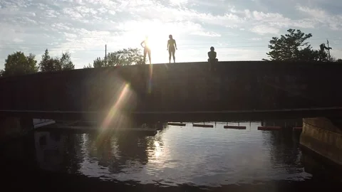 3 friends bridge jumping Stock Footage 167046308