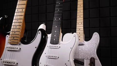 3 Guitars In Motion against black background Stock Footage 242383899