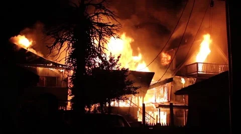 3 houses burning side by side in residential neighborhood at night Stock Footage 41074616