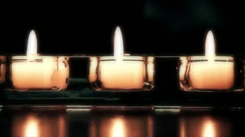 3 intimate tea candles on a dark backdrop (Looped) Stock Footage 12228266