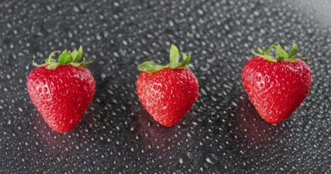 3 Juicy Red Strawberries Sprayed w/ Mist Stock Footage 138541857