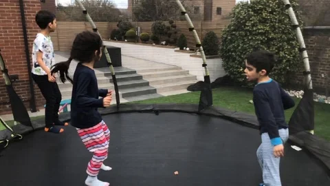3 kids having fun on a trampoline Stock Footage 88302896
