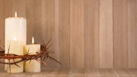 3 Lit Candles surrounded by Crown of Thorns on the left on the frame. Video stock 128713626