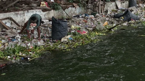 3-man-collects-recyclable-materials-from-lake-trash Stock Footage 93973978