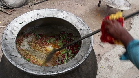 3-man-cooking-open-fire-large-pot-Hyderabad-India Stock Footage 93348224
