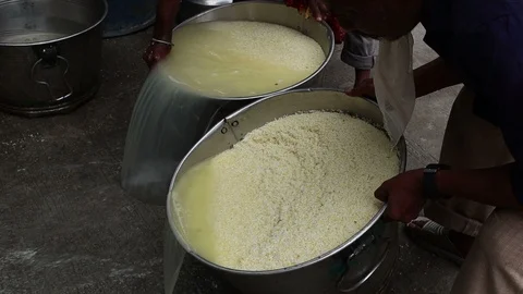 3-man-washes-rice-in-India Stock Footage 93378710