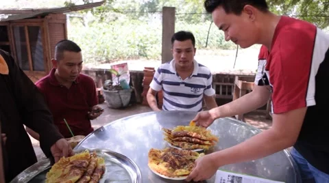 3 men sitting at table being served food in Vietnam Stock Footage 61118960