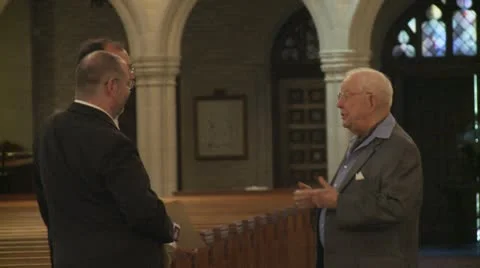 3 men talking in church Stock Footage 10712428