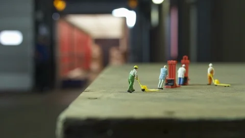3 miniature model workers on pallet while filling up truck in background Stock-Footage 102554924