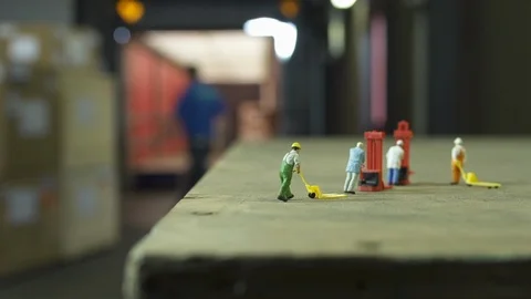3 miniature model workers on pallet while filling up truck iwith cardboard boxes Stock Footage 102554926