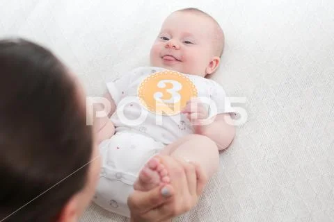 3 Month Old Cute Baby Girl, Infant ,lying on the white chanting table, laughs, l Stock Photos
