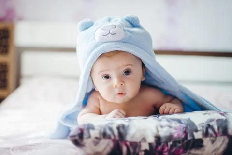 3 months baby boy weared in funny hat lying down on a blanket. A portrait of  Stock Photos