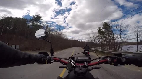 3 motorcycles on scenic road along water Stock Footage 49741253