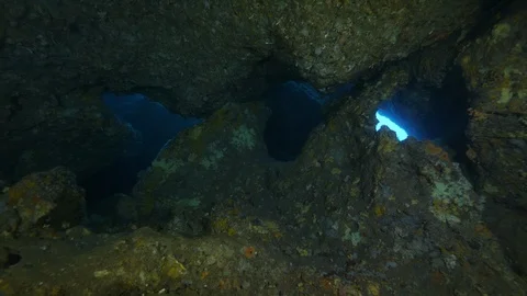 3 openings in the rocks that show the blue sea,Ustica, Sicily,Mediterranean sea  Stock Footage 126694448