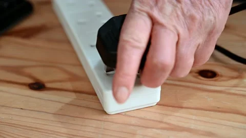 A 3 pin plug is plugged in to a multi socket extension block 스톡 동영상 170499045