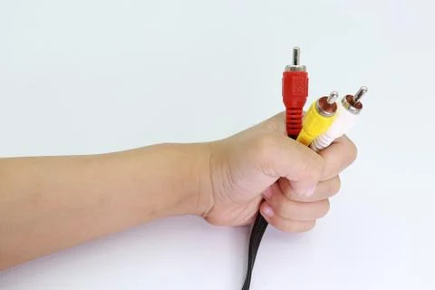 3 RCA Jack Plug Adapter Audio in kid hand isolated on white background. Stock Photos