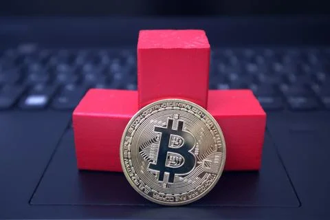 3 red blocks and bitcoin on black laptop Stock Photos