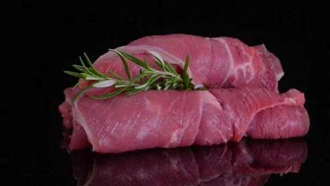 3 rolls of raw red meat rotated on isolated black background, Stock Footage 125191144