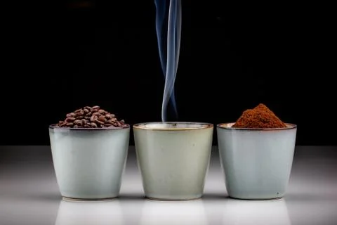 3 rustic coffee cups with coffee grounds, smoking coffee, and ground coffee. 写真素材