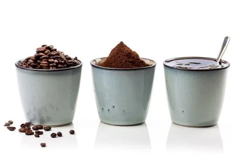 3 rustic coffee cups filled with hot coffee, beans, and ground coffee. White Stock Photos