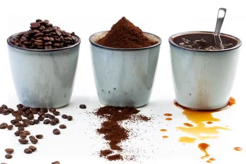 3 rustic coffee cups filled with hot coffee, beans, and ground coffee. White Stock Photos