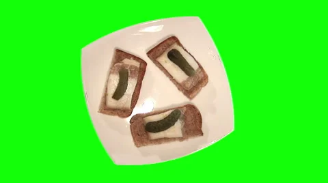 3 sandwiches with bread, pickled cucumbers and pork lard on plate, top shot Stock Footage 47844054