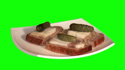 3 small sandwiches with bread, pickled cucumbers and pork lard on plate Stock Footage 47599487
