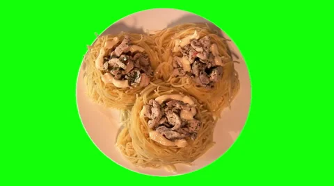 3 spaghetti nests with chicken pieces on plate, top shot Stock Footage 47559173